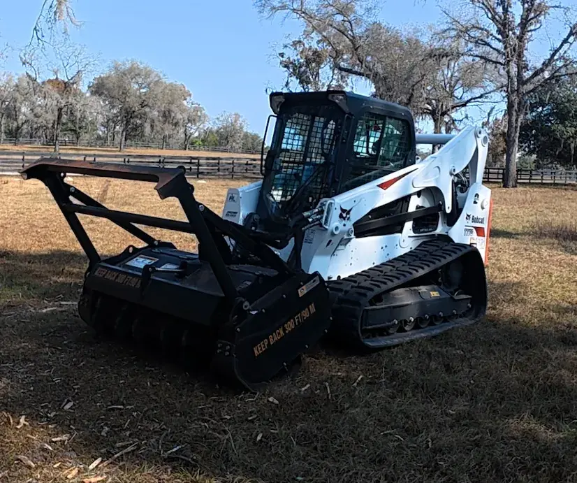 Bobcat skid steer with a forestry mulching head