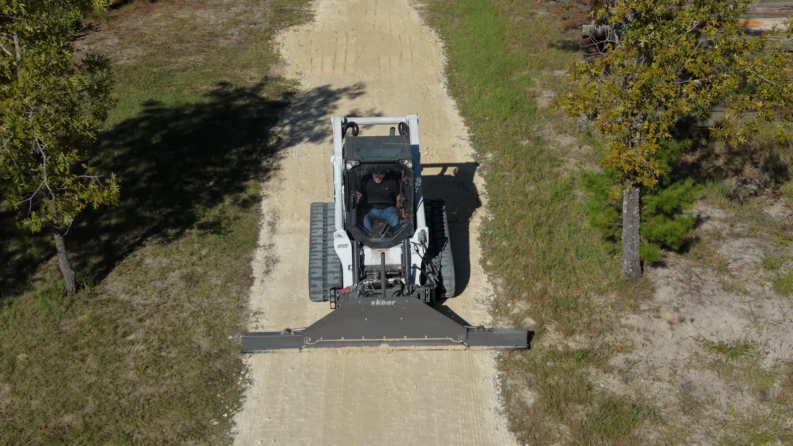 Skid steer grading rural access in Williston